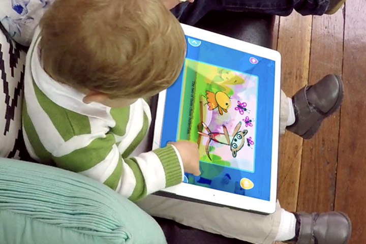 Toddler playing a Reading Eggs Junior activity on a tablet